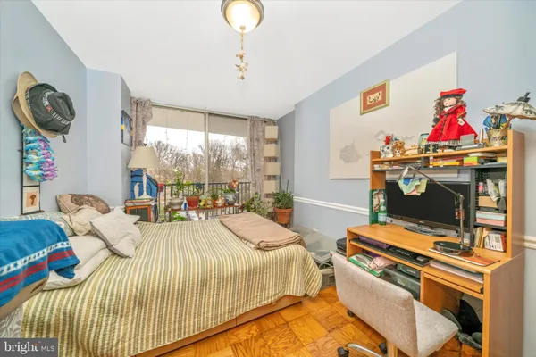 a bedroom with a bed and a large window