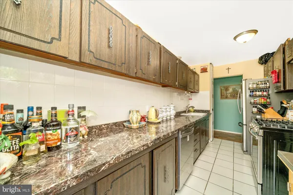 a kitchen with stainless steel appliances granite countertop a stove and a sink