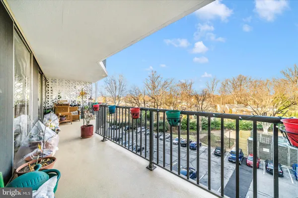 a view of a building and car parked on the side of road