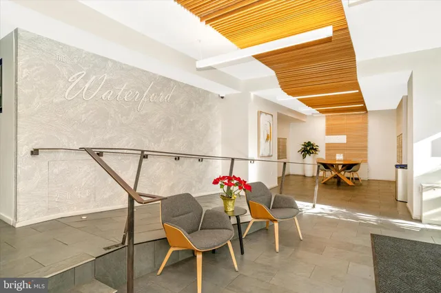 a dining room with furniture and a potted plant