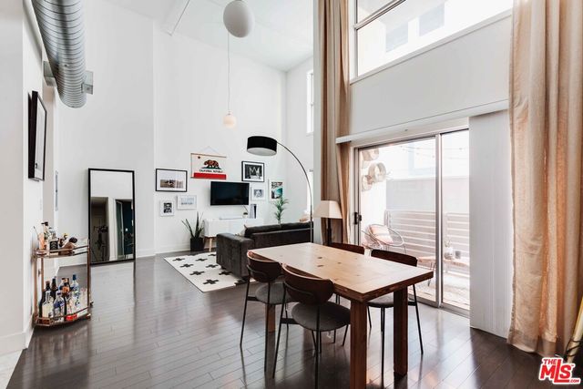 a living room with furniture a table and a large window