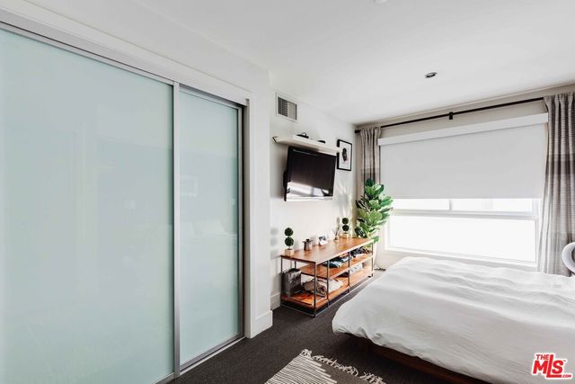 a room with a bed and a flat screen tv