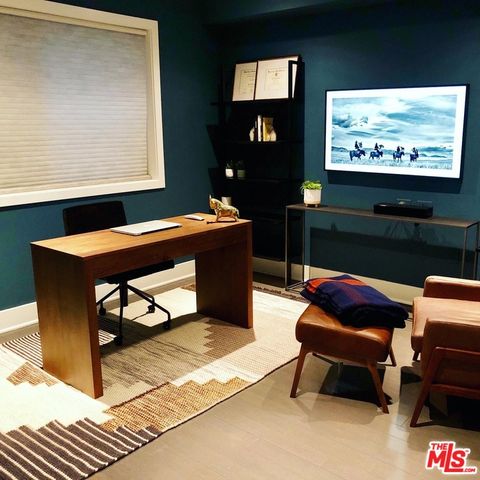 a living room with furniture a rug and a flat screen tv