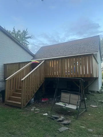 a view of balcony with wooden floor and fence