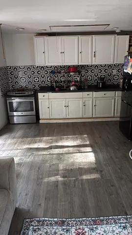 a view of a kitchen has white cabinets