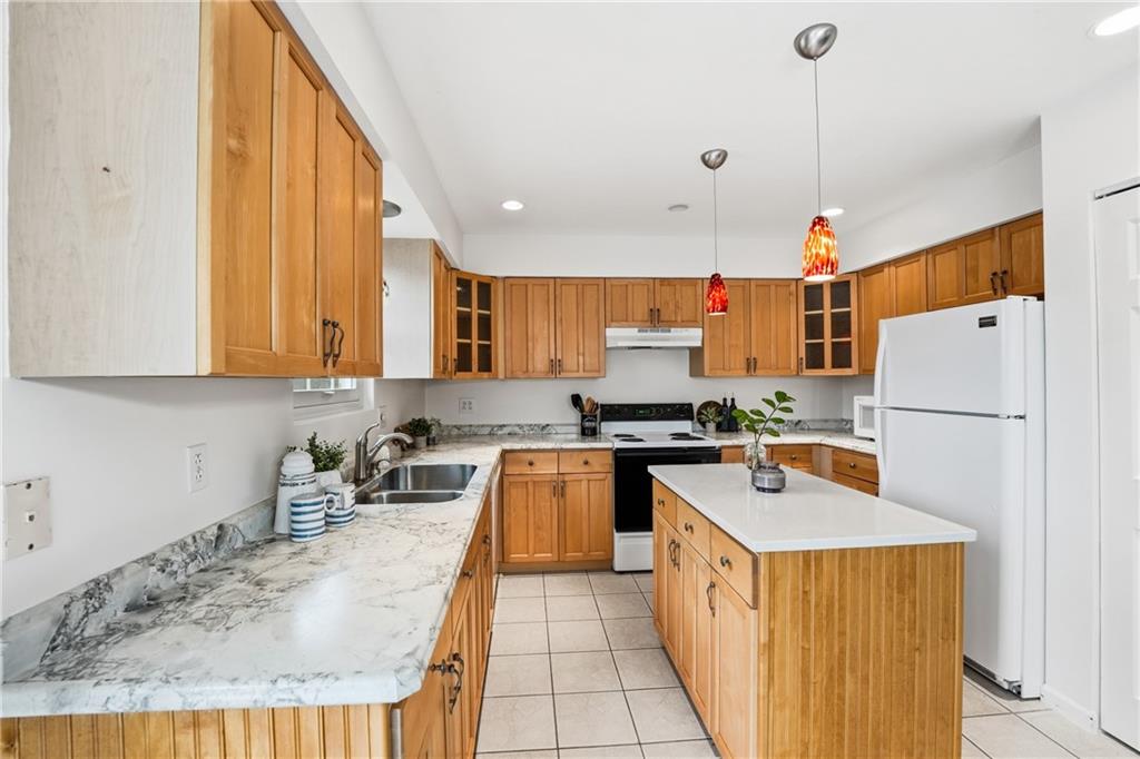 3699 Mitchell Road New Castle, PA 16105 - Photo 7 of 14 a kitchen with a sink a counter top space stainless steel appliances and cabinets