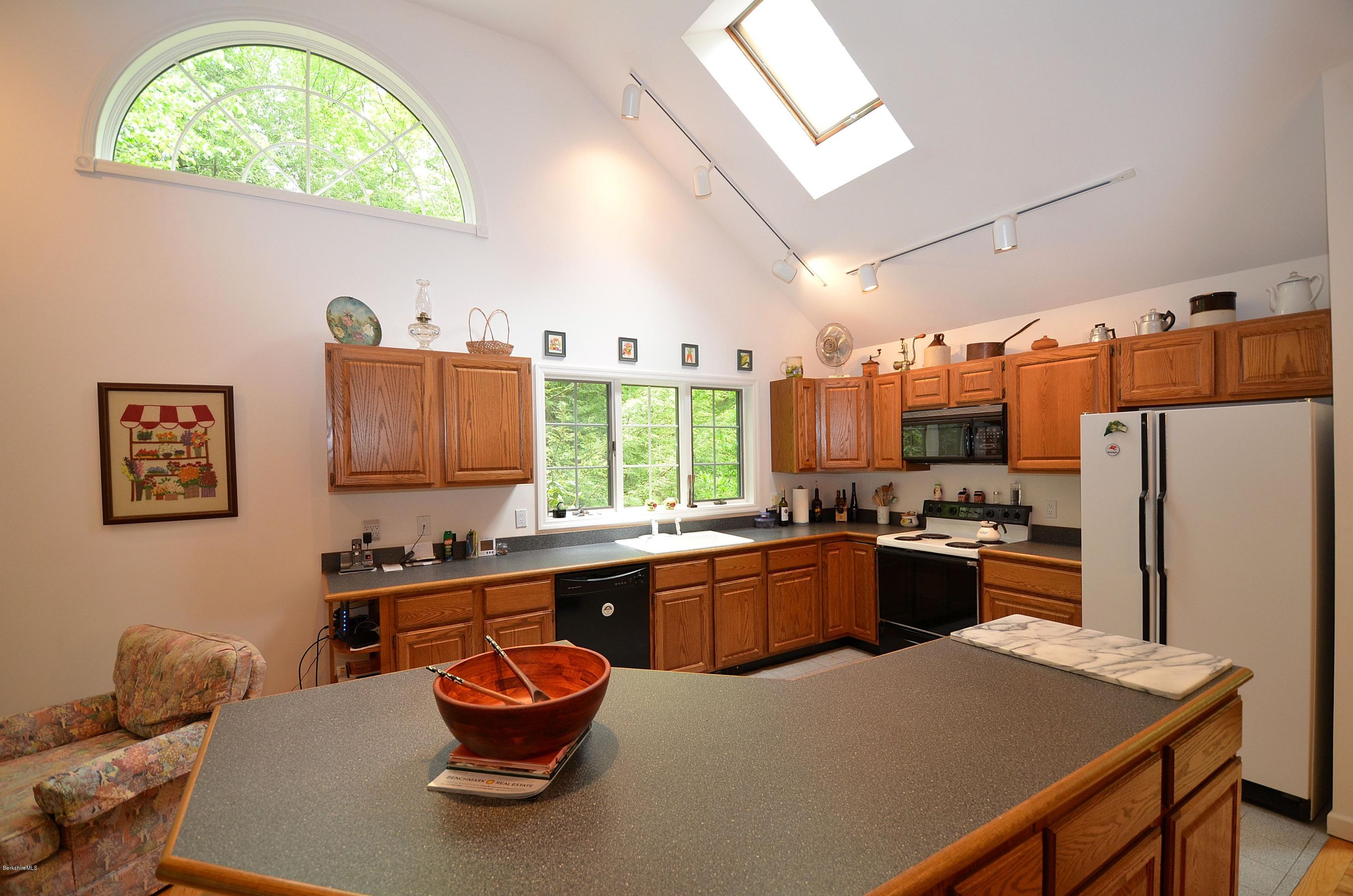 52 Monterey Road Tyringham, MA 01264 - Photo 3 of 10 a kitchen with a refrigerator and a stove top oven
