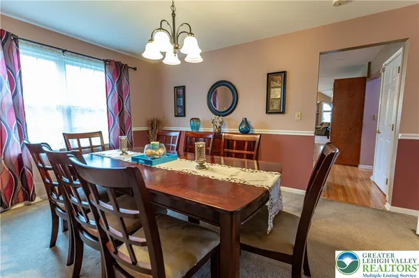 a kitchen with a sink cabinets and dining table chair