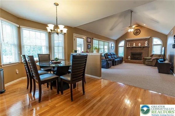a living room with furniture a large window and a flat screen tv