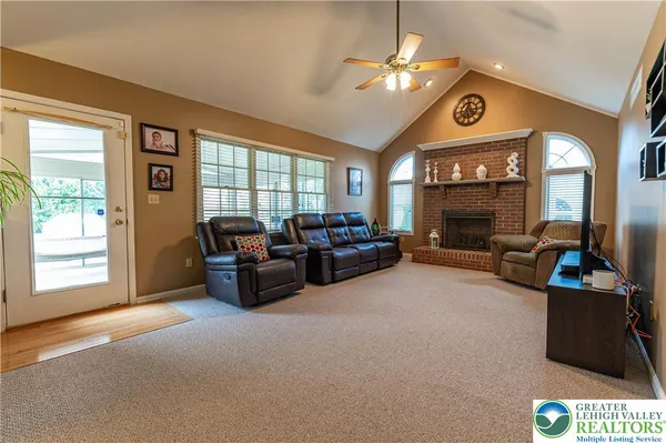 a view of a hallway with a livingroom to stairs