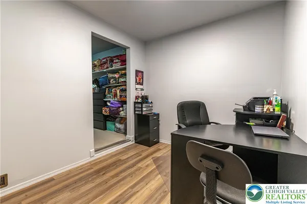 a bedroom with a bed and dresser with mirror