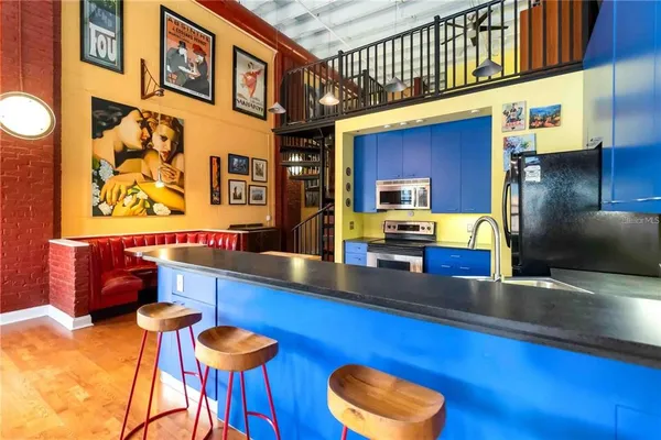 a kitchen with stainless steel appliances wooden cabinets a stove top oven a sink and dishwasher