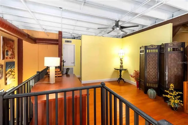 a view of a room with furniture large windows and front door