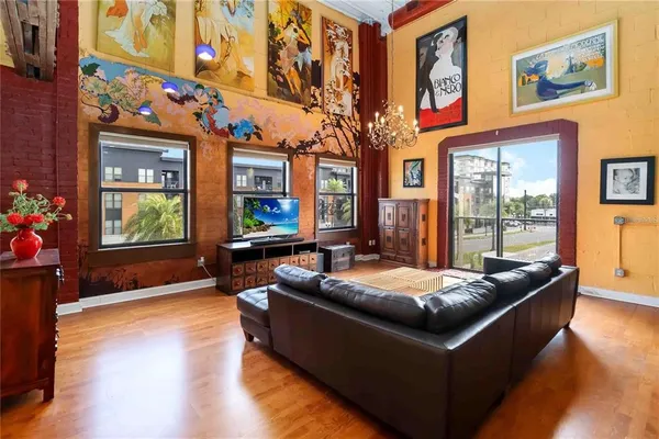 a kitchen with stainless steel appliances kitchen island granite countertop a table chairs in it and wooden floors