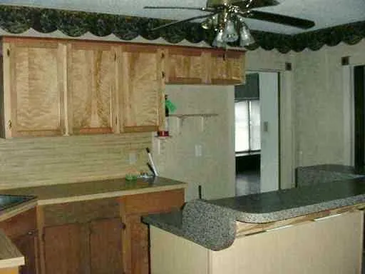 a bathroom with a granite countertop sink and a shower
