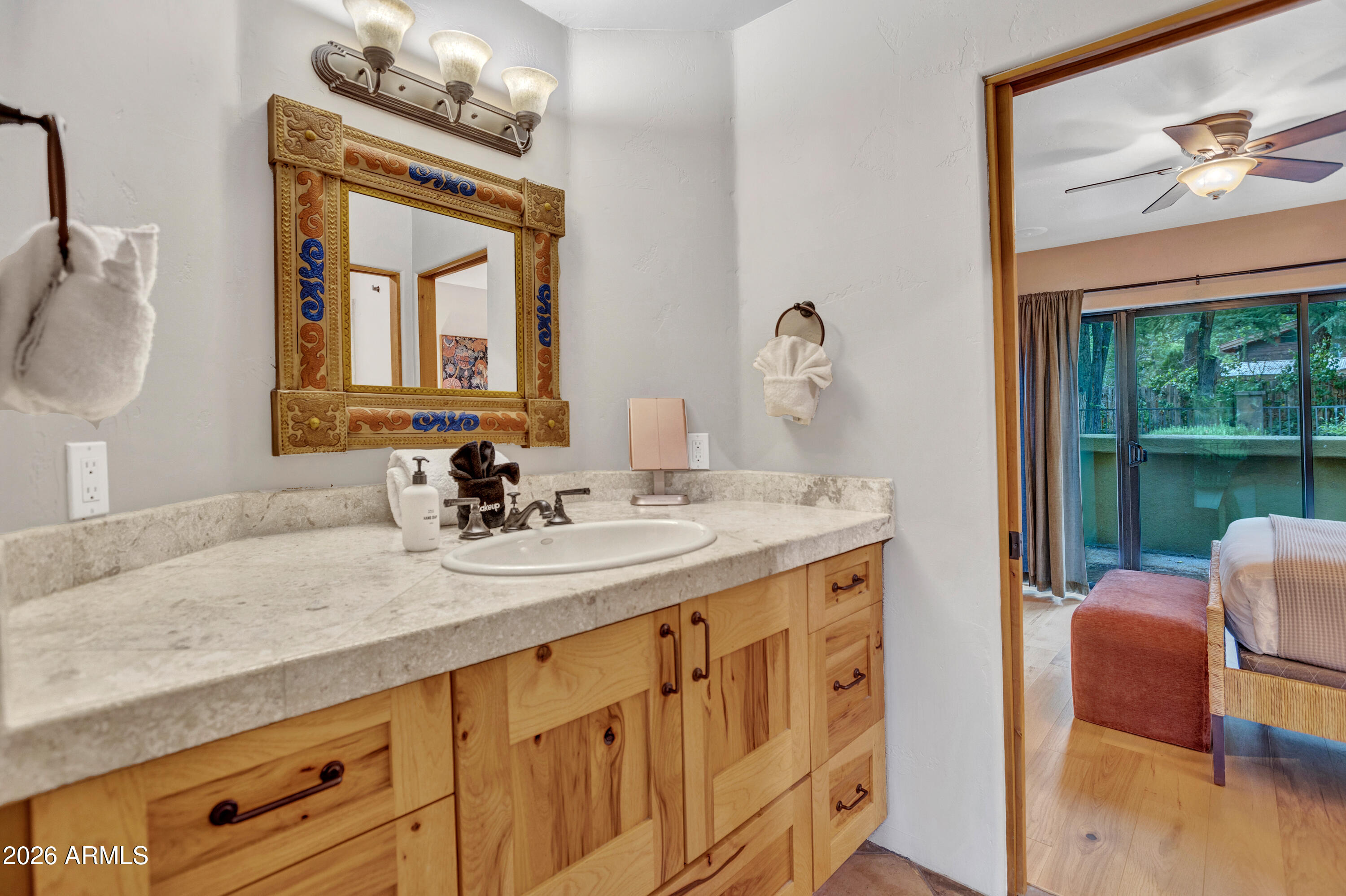 55 Ranch House Circle Sedona, AZ 86336 - Photo 24 of 61 a bathroom with a granite countertop sink and a mirror
