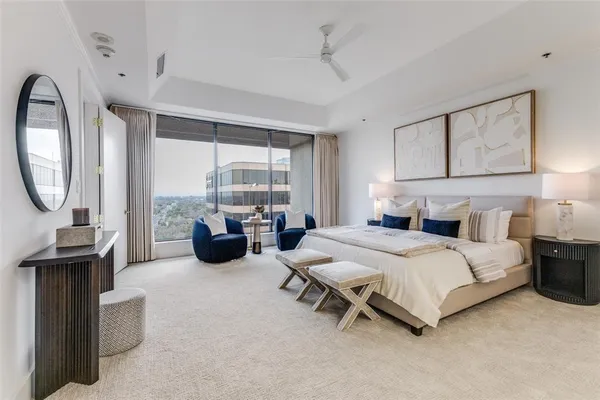 a bedroom with bed and a chandelier
