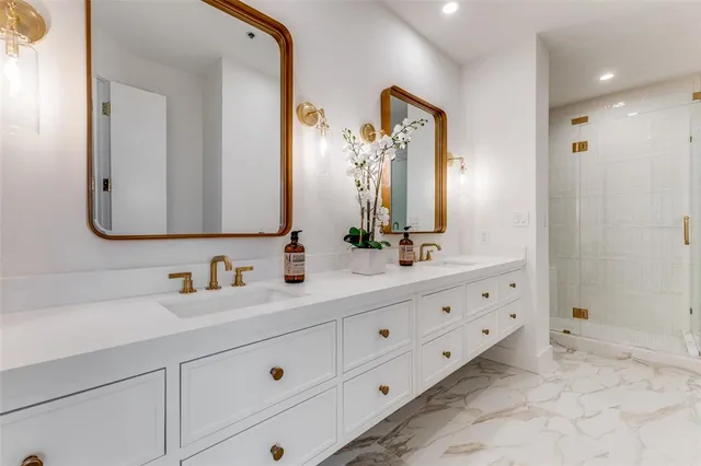 a bathroom with double sink and a mirror