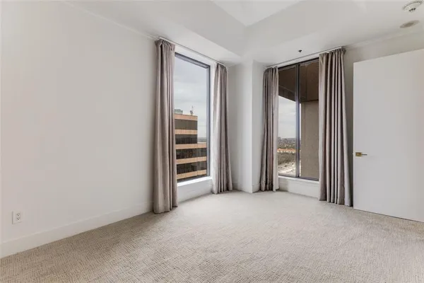 an empty room with windows and closet