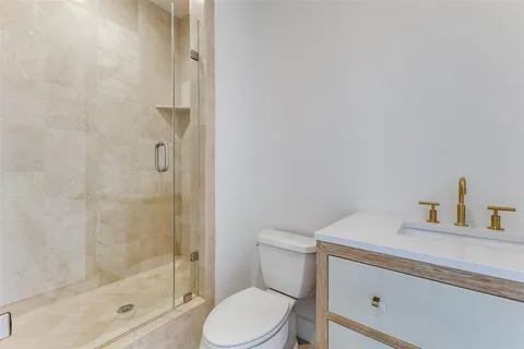 a white toilet sitting next to a bathroom sink