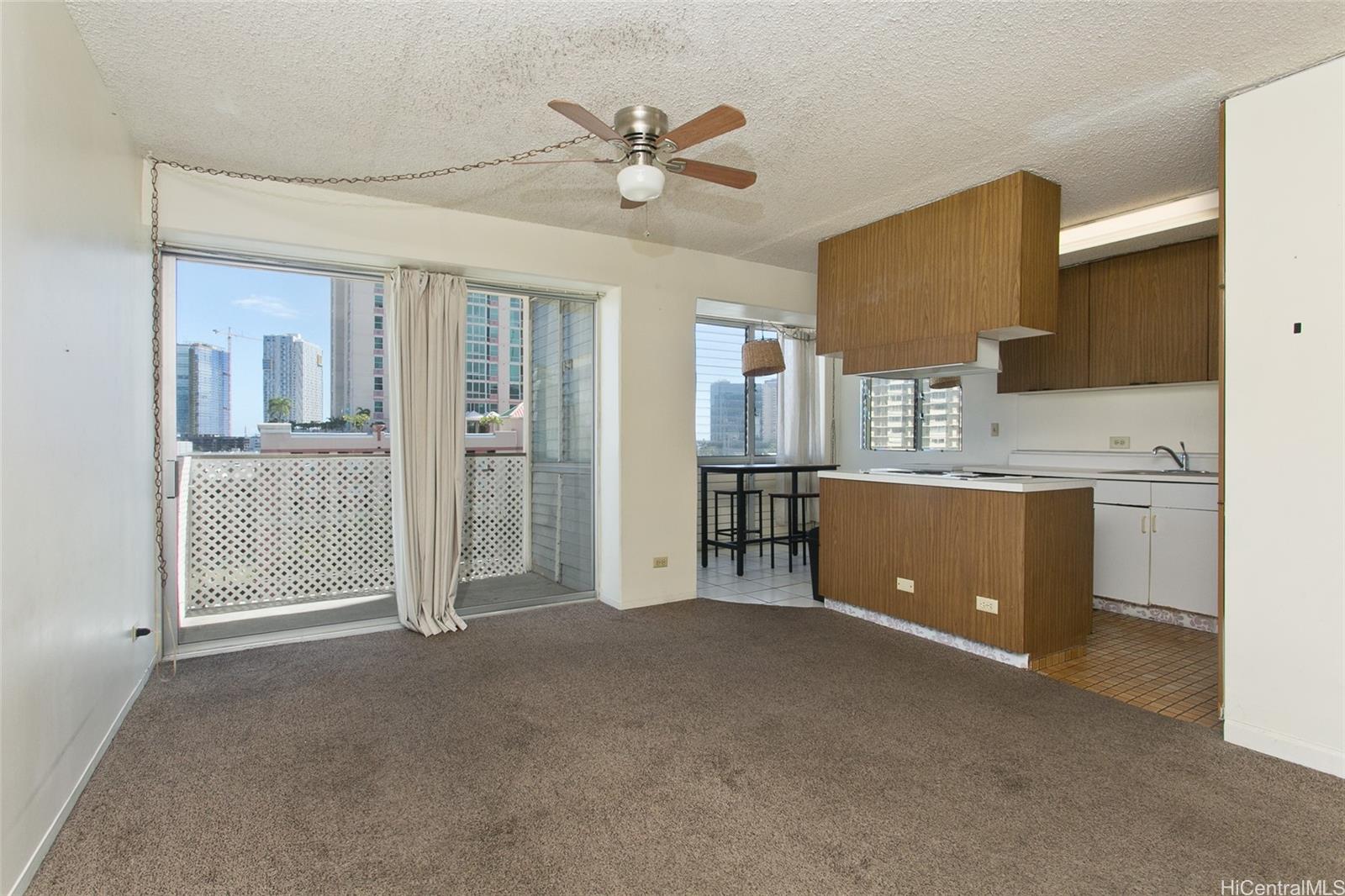 818 South King Street, Unit 907 Honolulu, HI 96813 - Photo 2 of 16 a view of an empty room with cabinet and a ceiling fan
