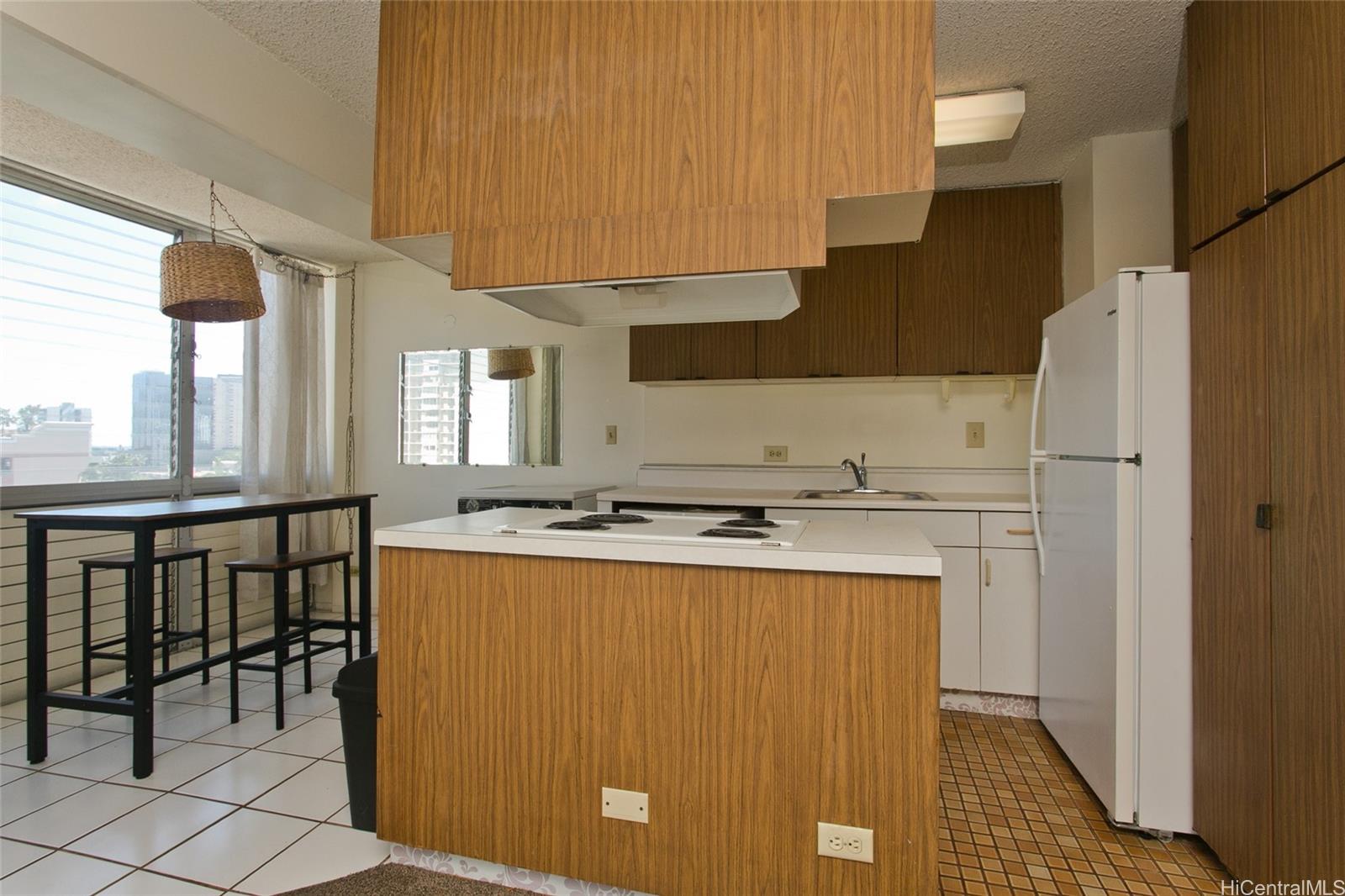 818 South King Street, Unit 907 Honolulu, HI 96813 - Photo 3 of 16 a kitchen with appliances a sink and cabinets