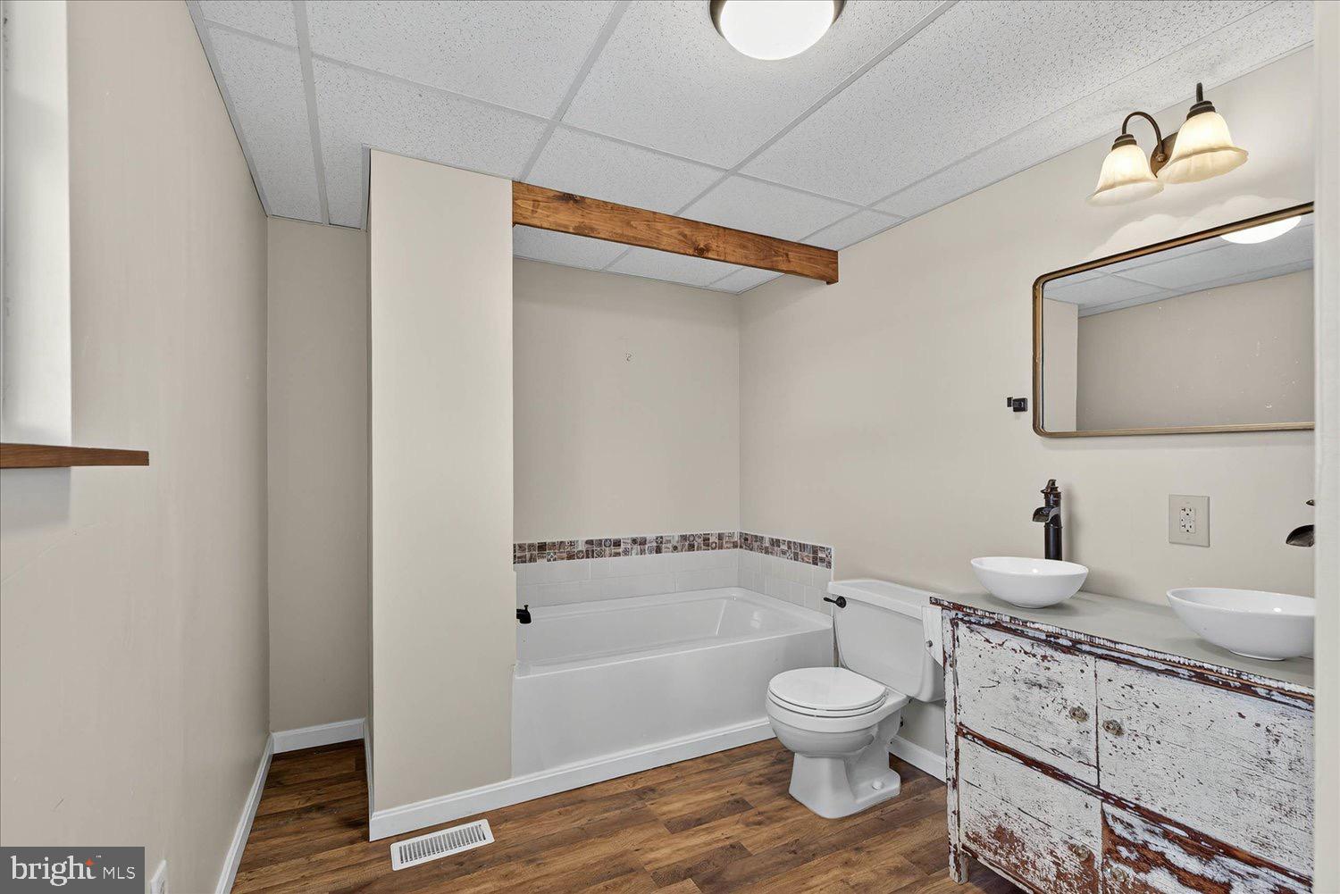 934 North Queen Street York, PA 17404 - Photo 16 of 35 a bathroom with a granite countertop toilet a sink and a bathtub