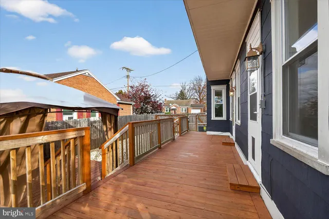 a view of a house with wooden deck
