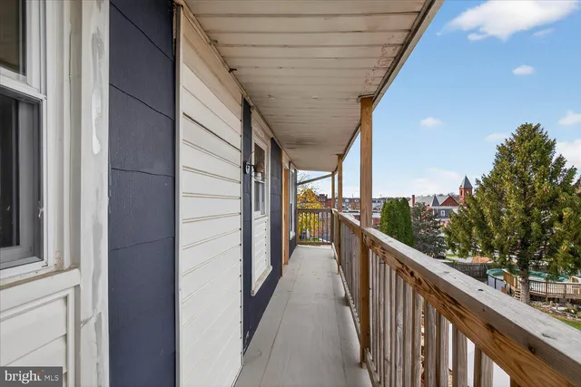 a backyard of a house with yard and outdoor seating