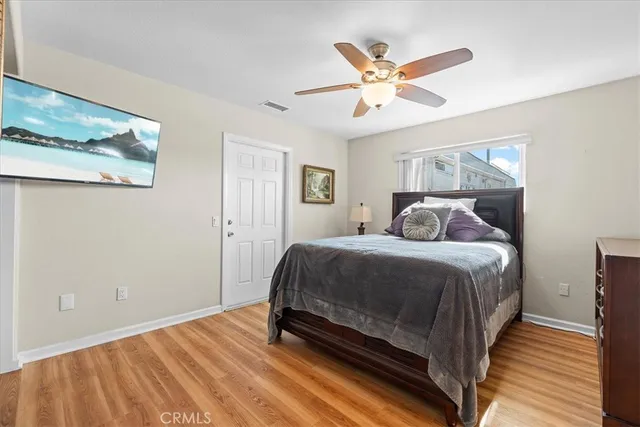 a bedroom with a large bed and a ceiling fan