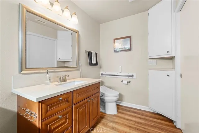 a spacious bathroom with a toilet sink and mirror