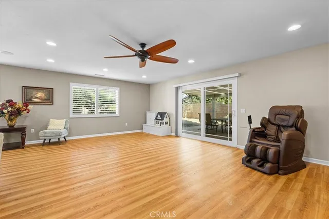 a view of a livingroom with a large window and wooden floor