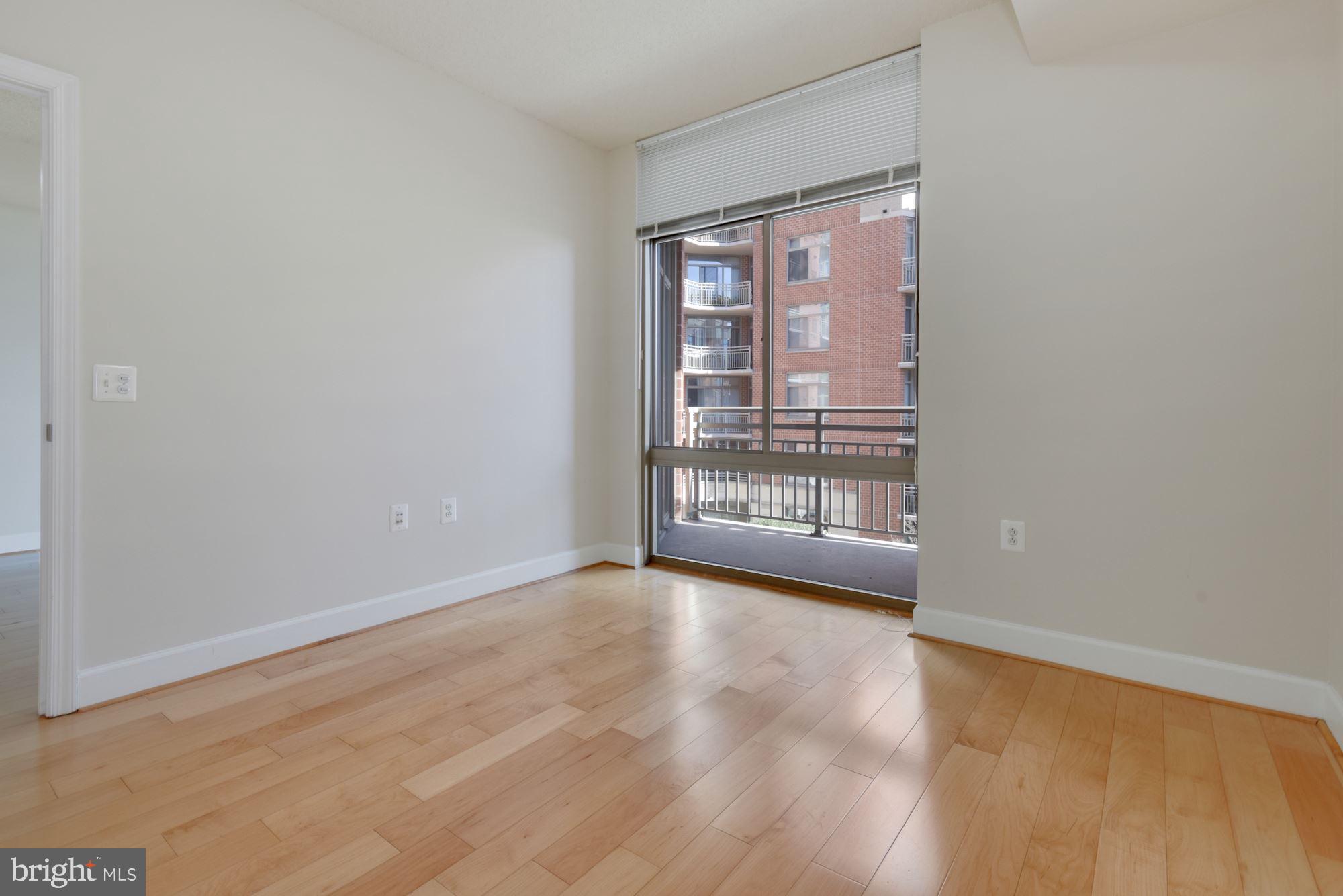 3600 South Glebe Road, Unit 434W Arlington, VA 22202 - Photo 12 of 36 an empty room with wooden floor and windows