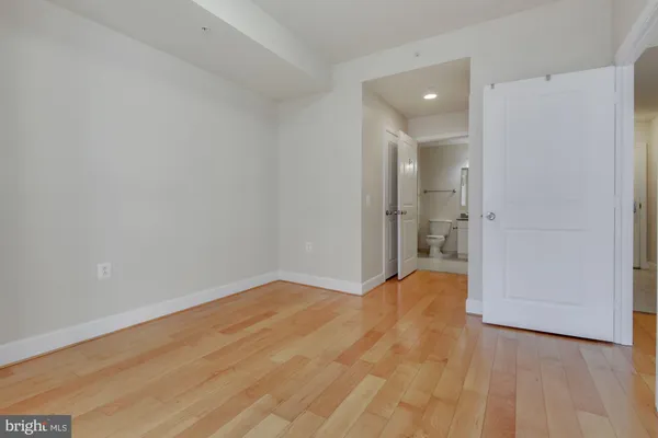 a view of a room with wooden floor and a sink