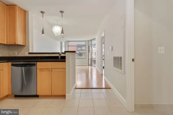 a kitchen with granite countertop a refrigerator and a stove top oven