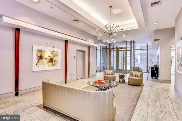 a living room with furniture and a chandelier