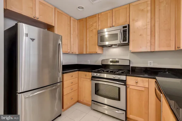 a kitchen with a stove microwave and refrigerator