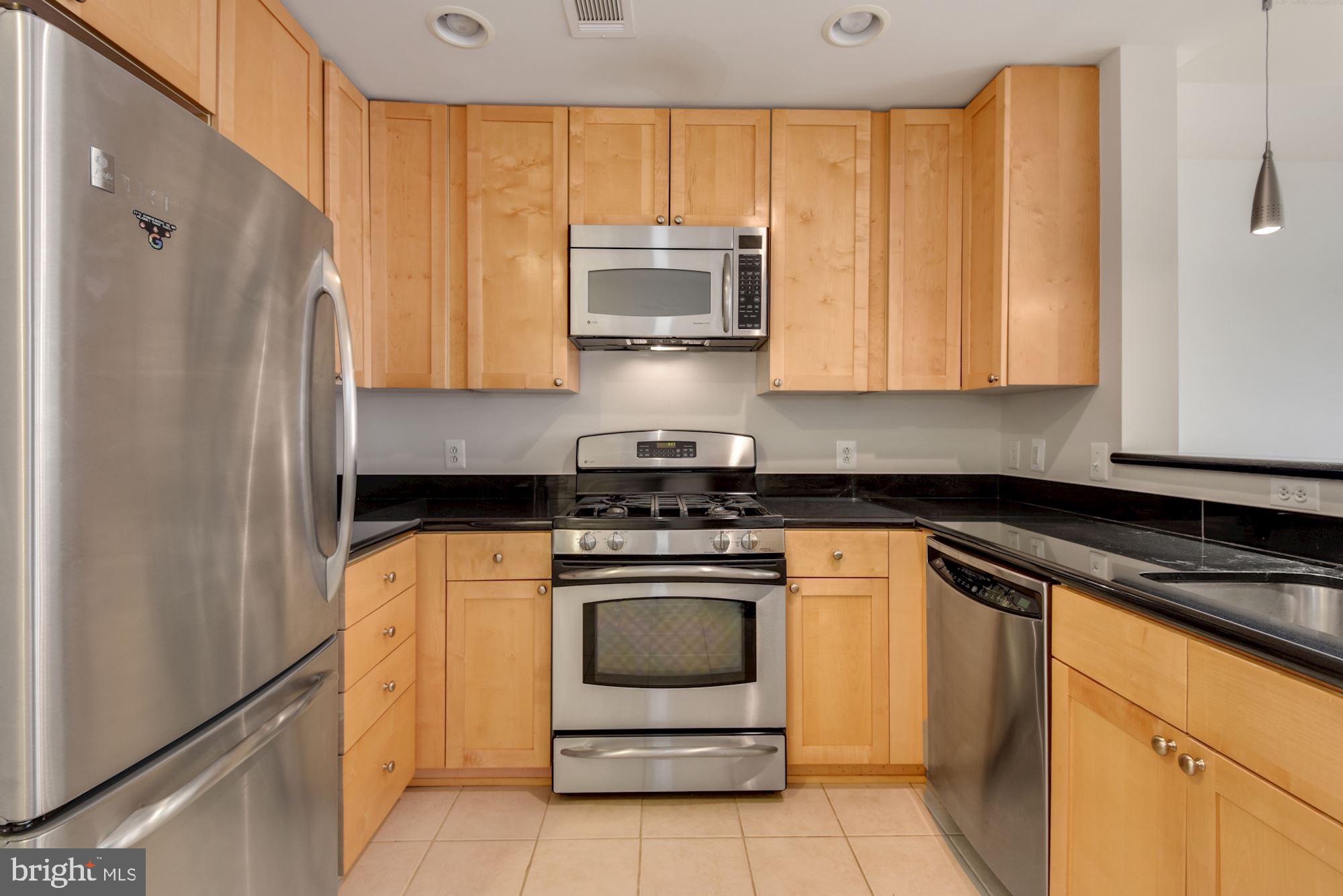 3600 South Glebe Road, Unit 434W Arlington, VA 22202 - Photo 5 of 36 a kitchen with stainless steel appliances granite countertop a stove a refrigerator and a microwave