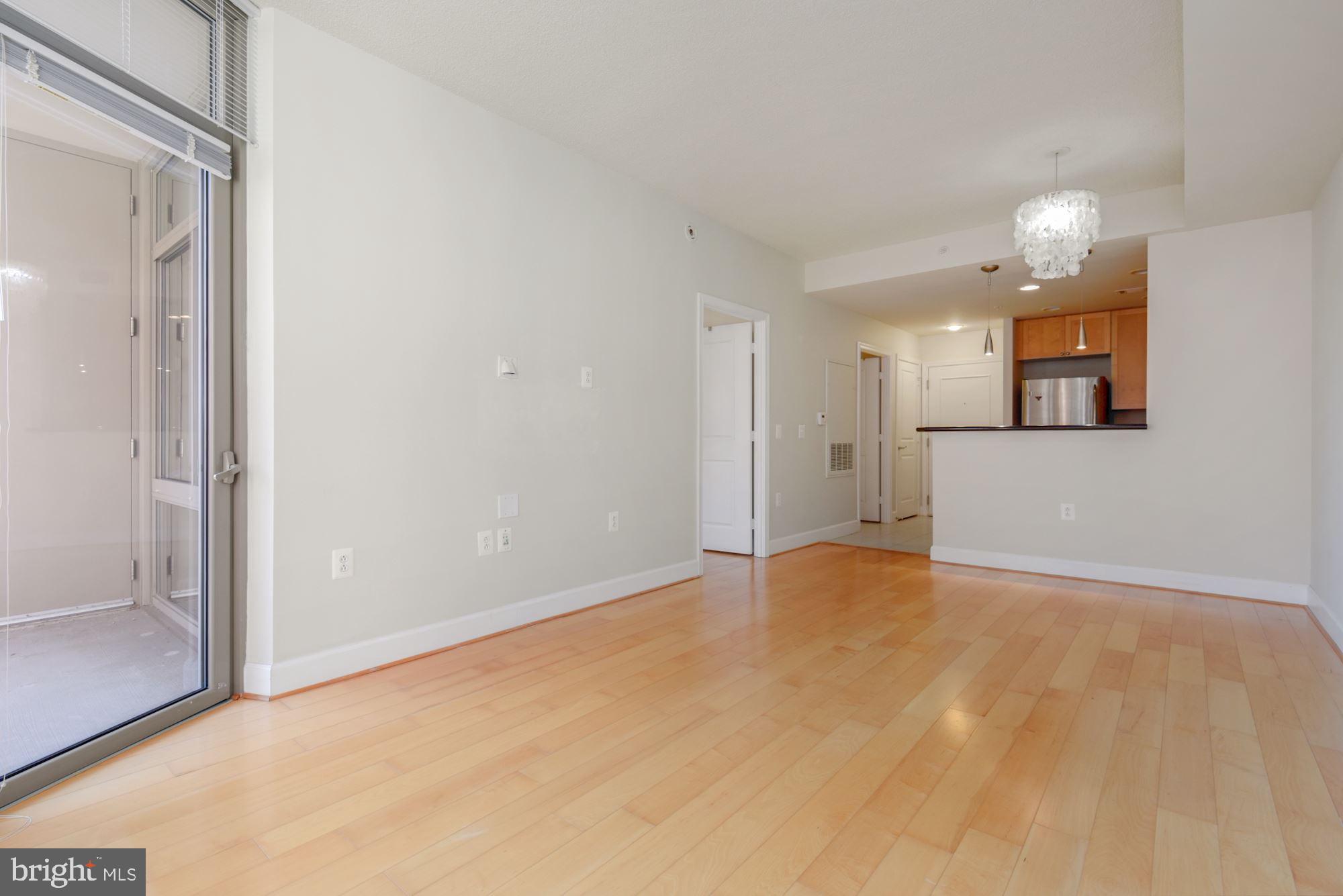 3600 South Glebe Road, Unit 434W Arlington, VA 22202 - Photo 9 of 36 a view of an empty room with window and wooden floor