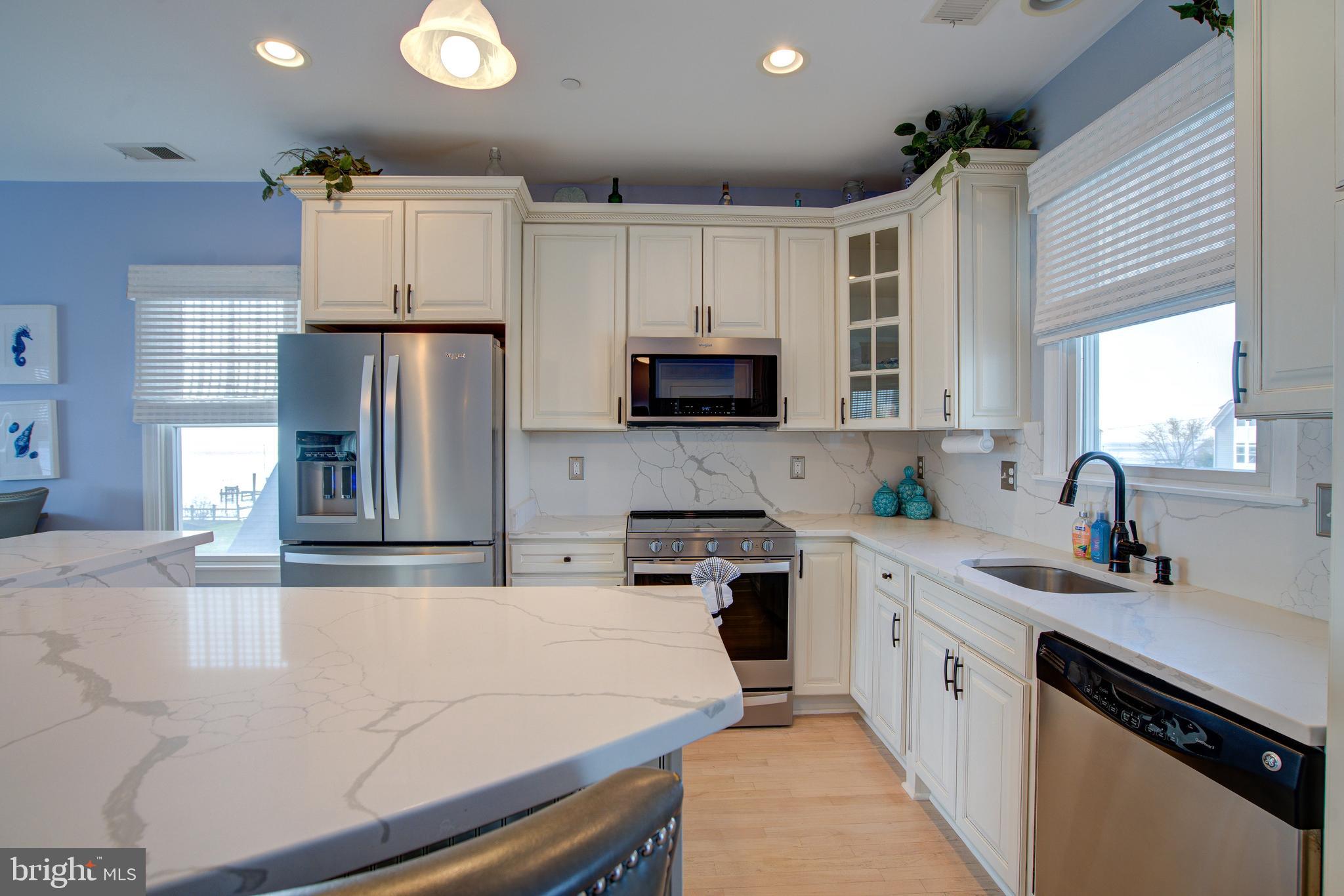 2811 Bay Drive Sparrows Point, MD 21219 - Photo 9 of 66 a kitchen with a sink stainless steel appliances and white cabinets