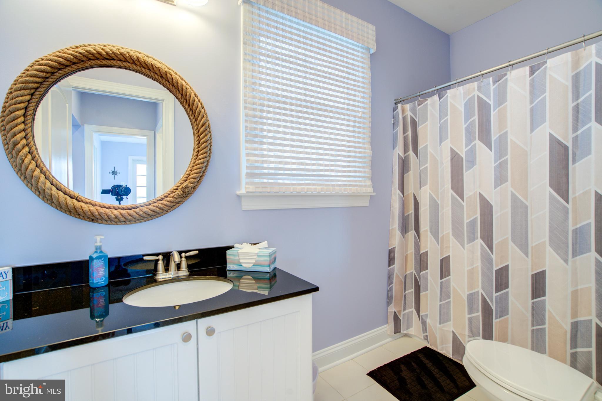 2811 Bay Drive Sparrows Point, MD 21219 - Photo 17 of 66 a bathroom with a sink and a mirror