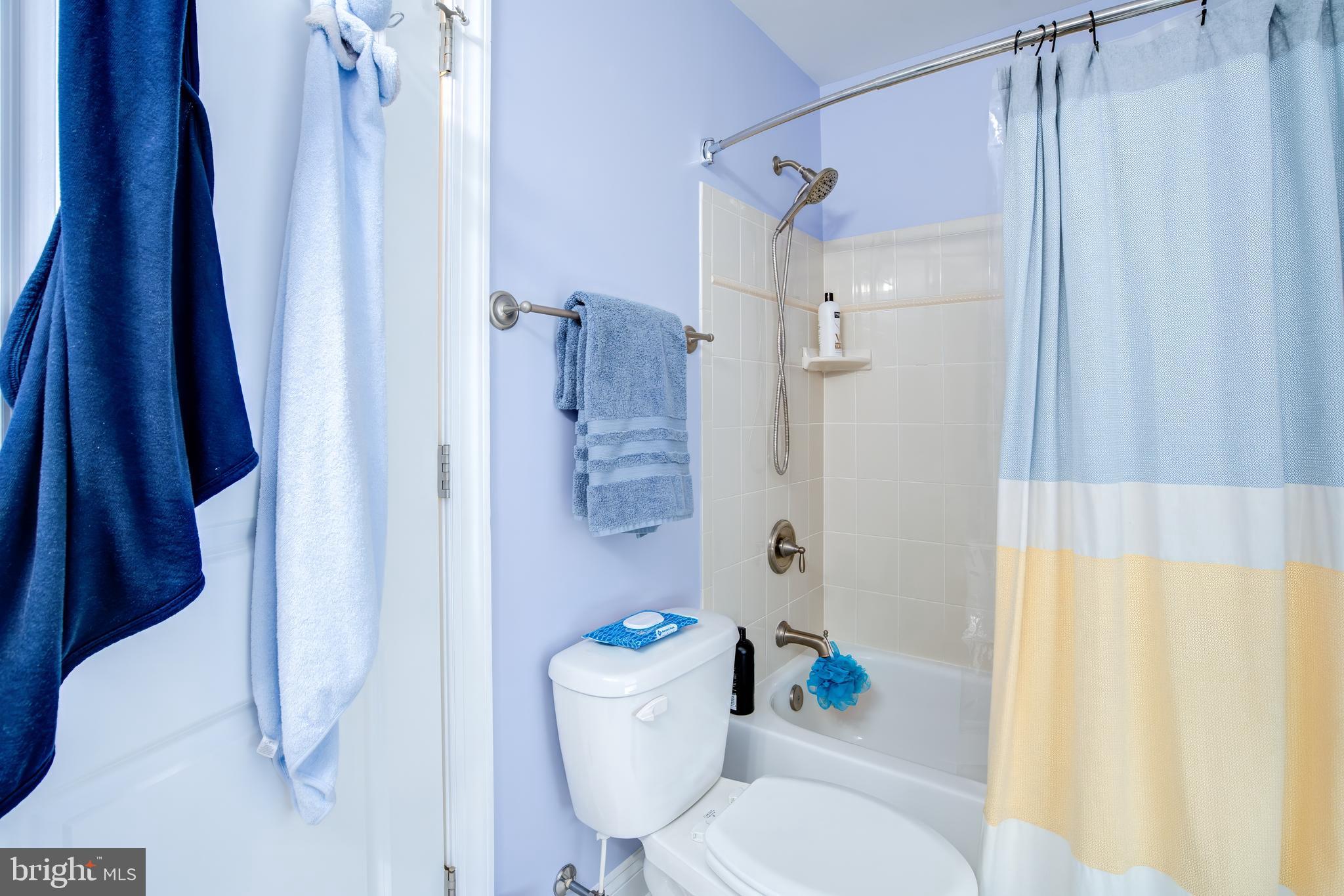 2811 Bay Drive Sparrows Point, MD 21219 - Photo 26 of 66 a bathroom with a toilet and a shower curtain