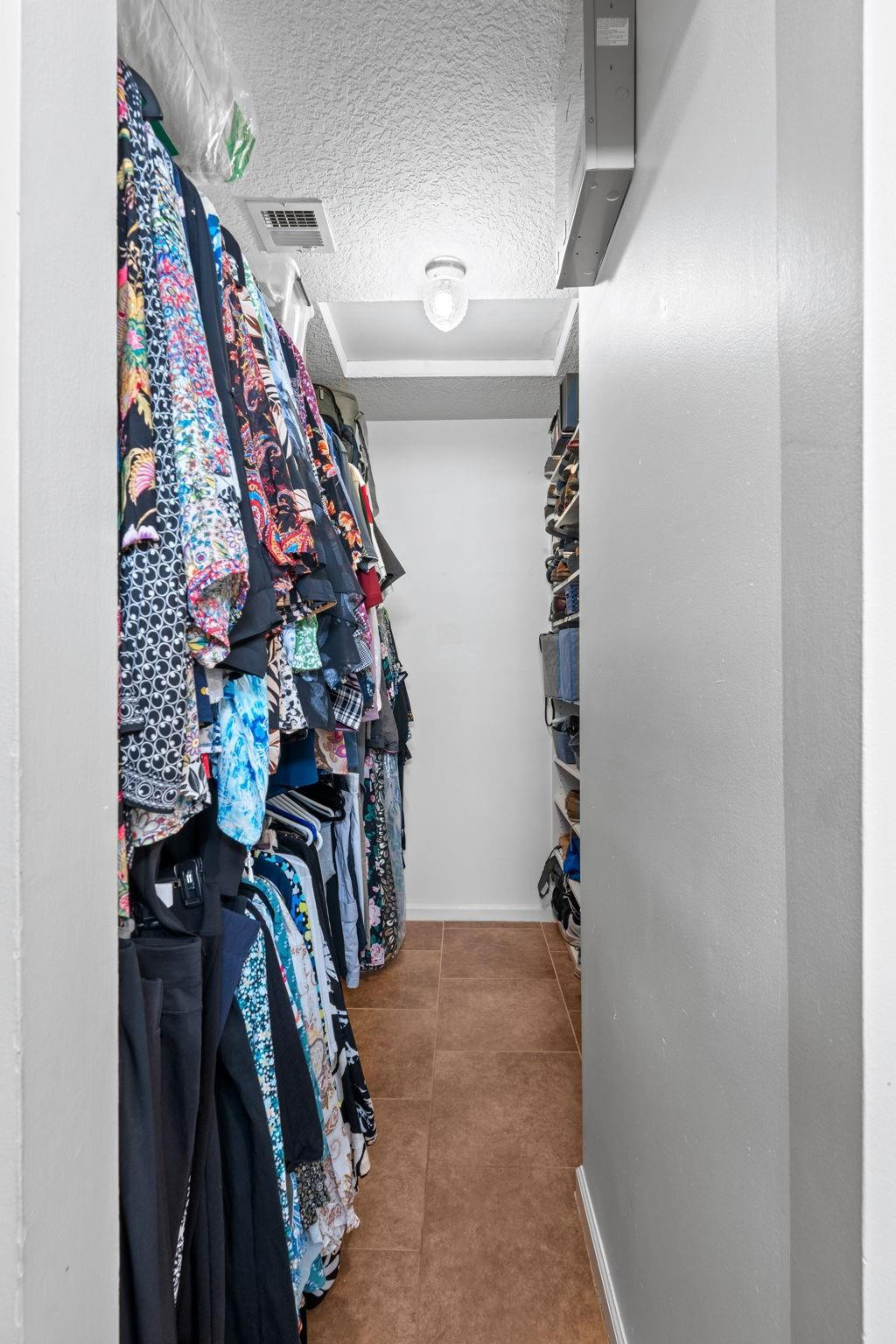 9601 Riverside Drive, Unit A6 Coral Springs, FL 33071 - Photo 19 of 25 a view of walk in closet with clothes