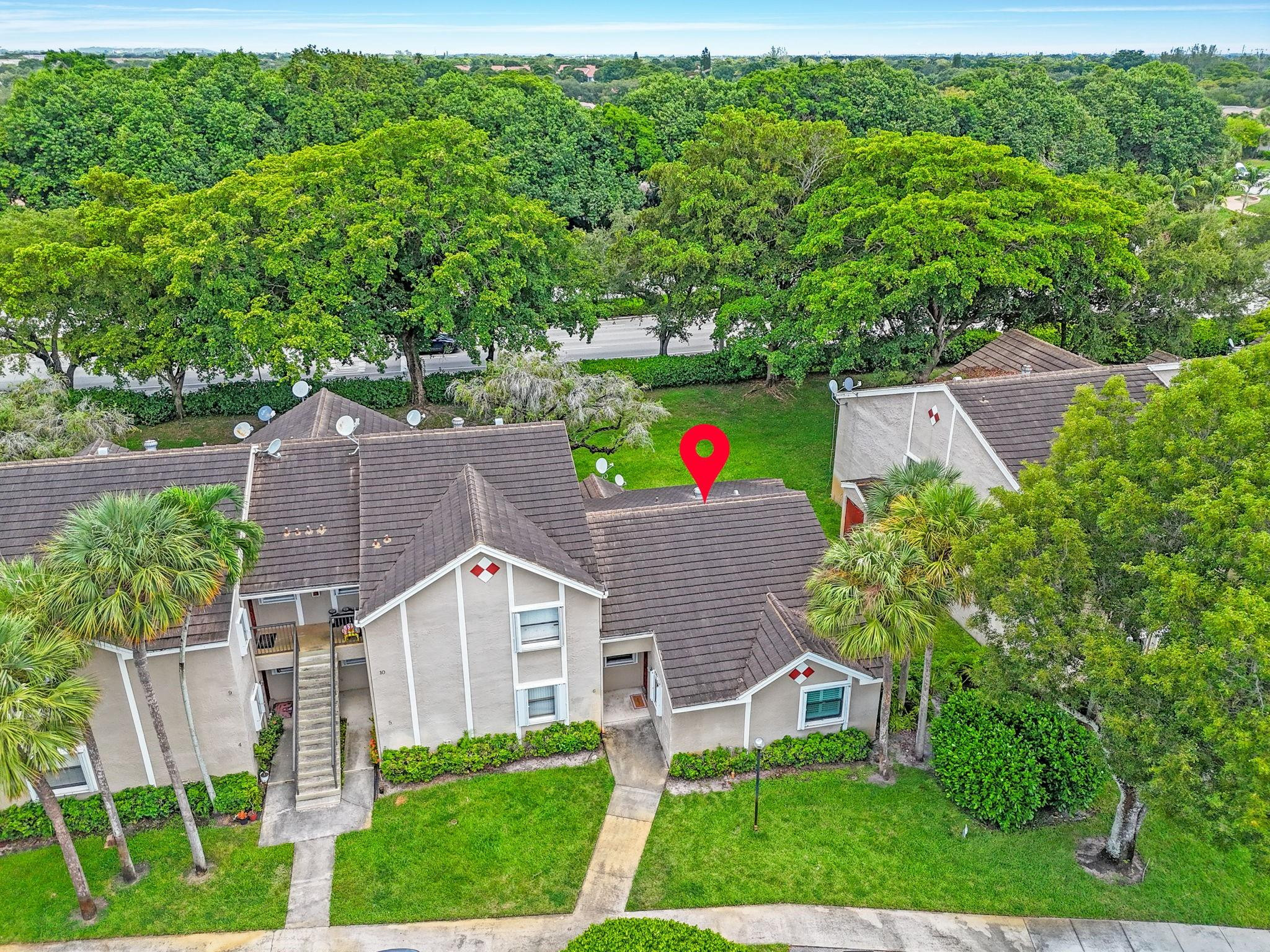 9601 Riverside Drive, Unit A6 Coral Springs, FL 33071 - Photo 24 of 25 an aerial view of a house with a big yard and large trees