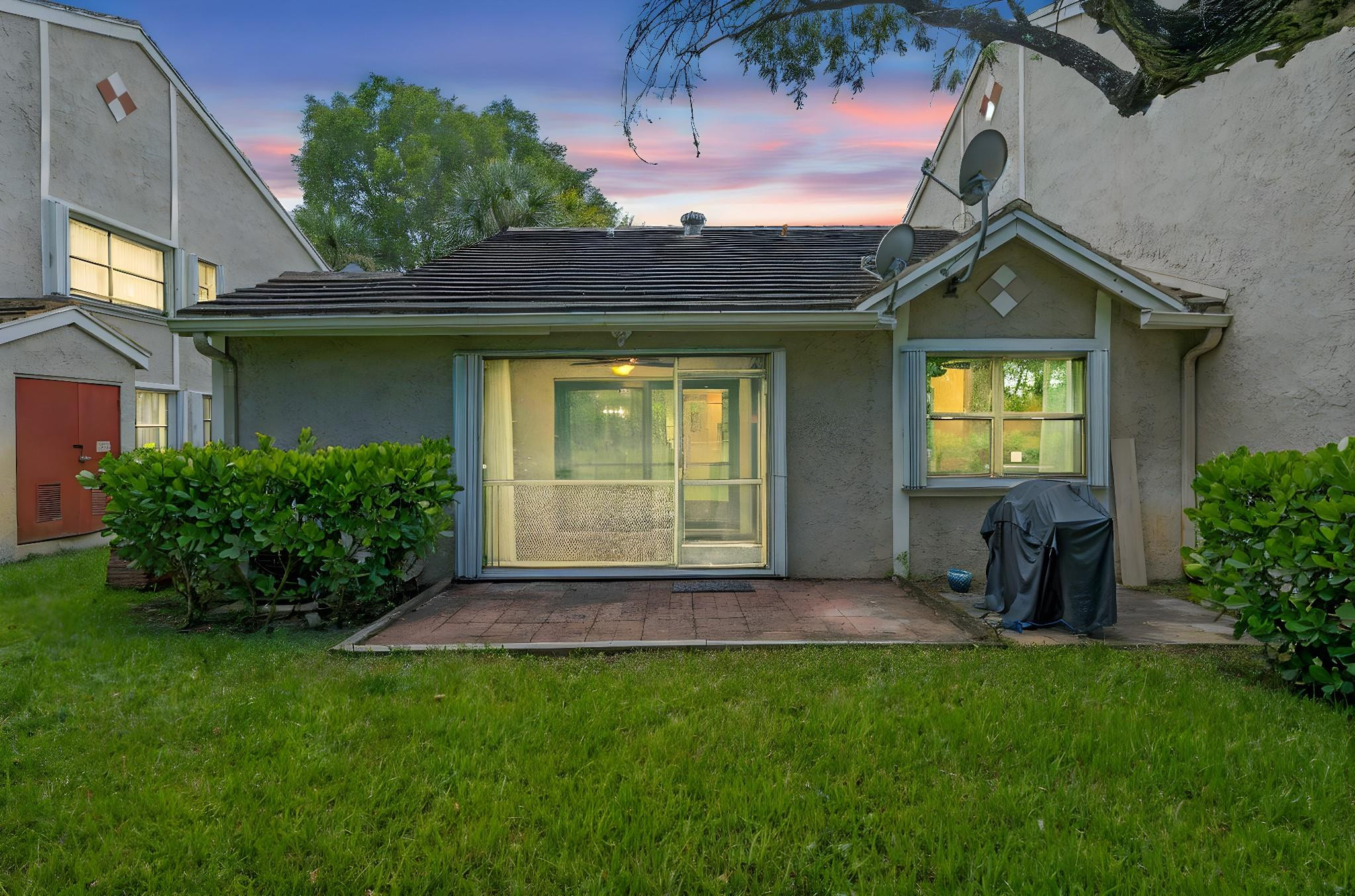 9601 Riverside Drive, Unit A6 Coral Springs, FL 33071 - Photo 3 of 25 a view of a house with a small yard and a garage