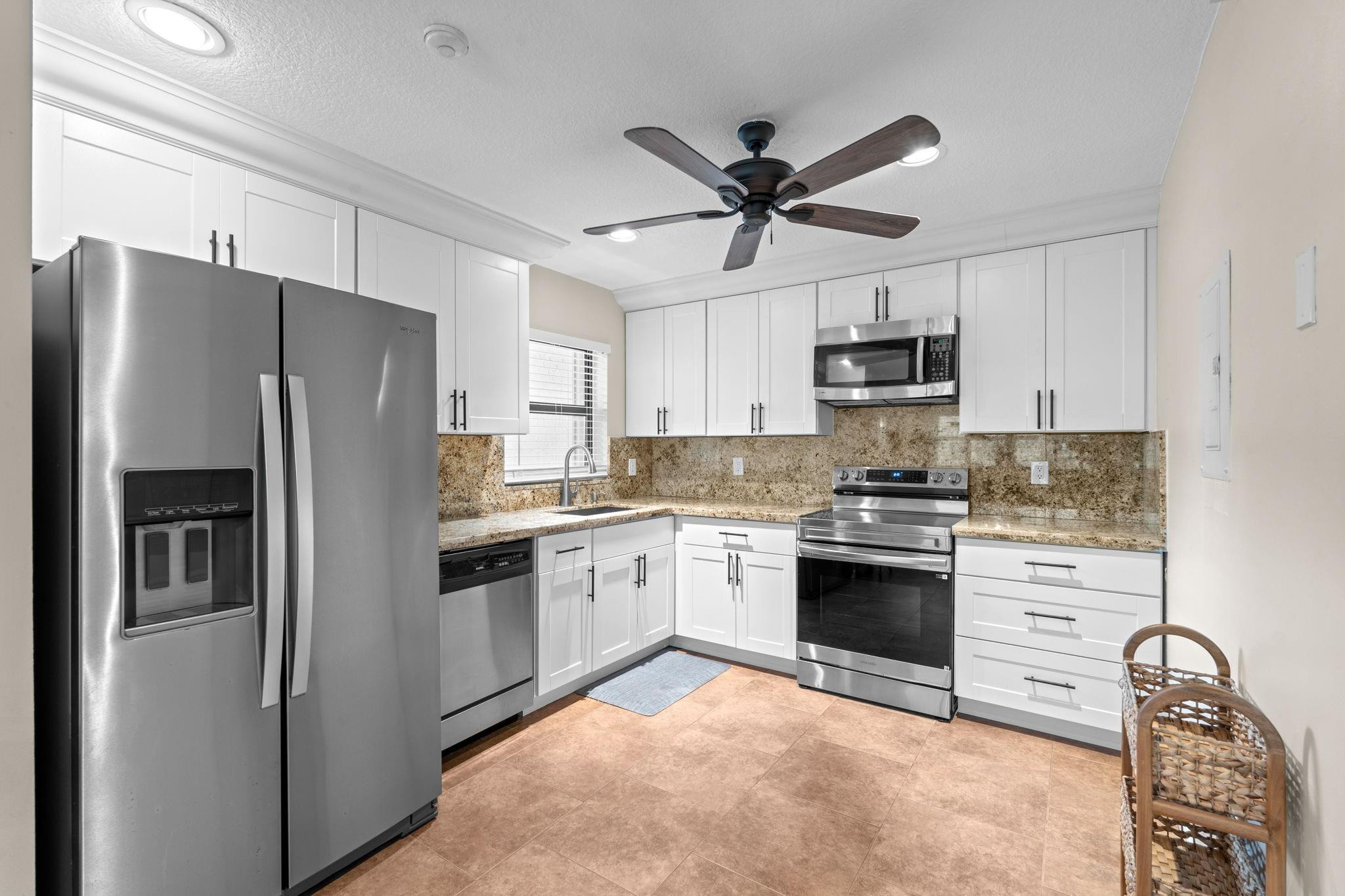 9601 Riverside Drive, Unit A6 Coral Springs, FL 33071 - Photo 4 of 25 a kitchen with stainless steel appliances granite countertop a refrigerator stove and sink