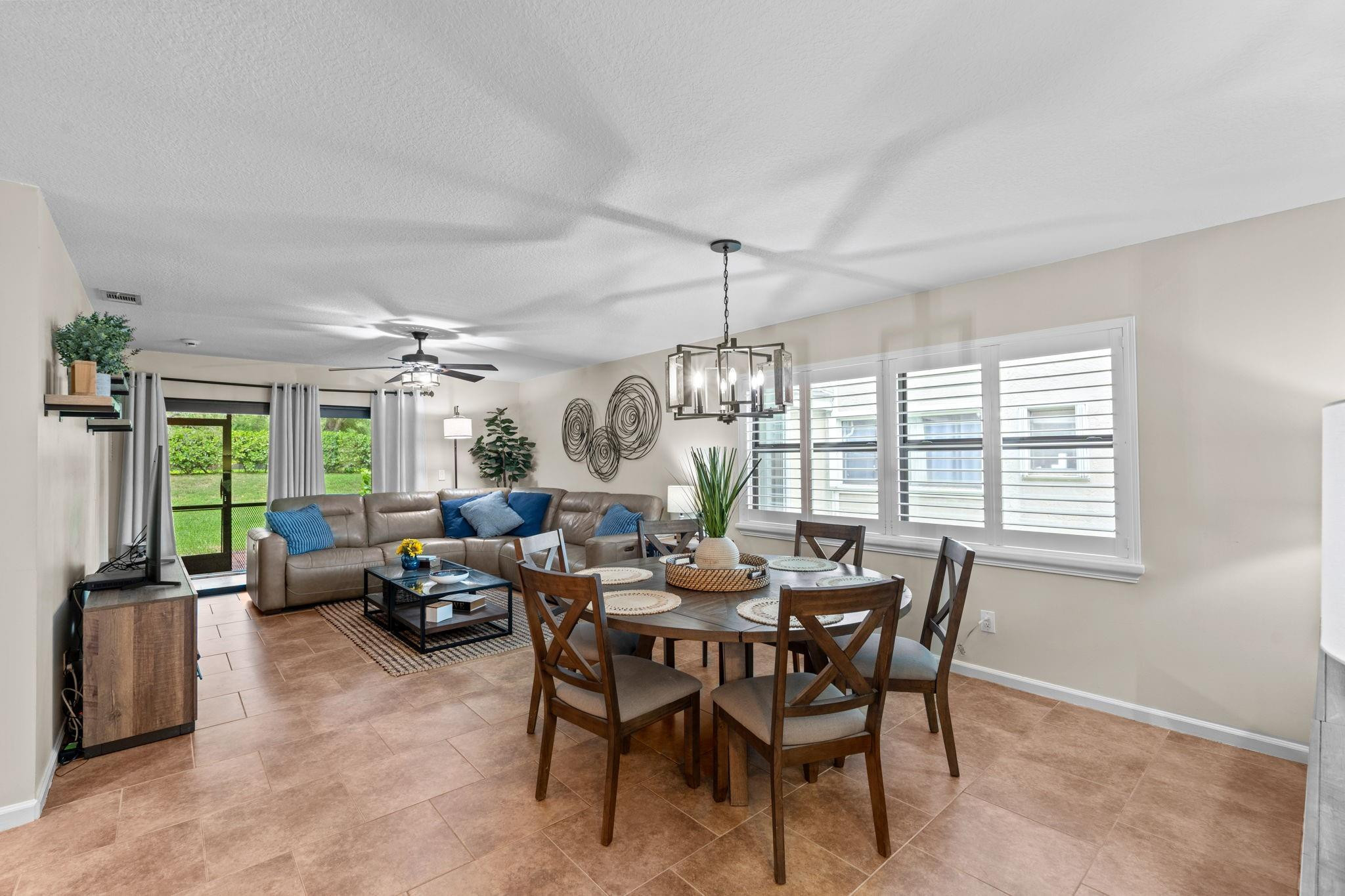 9601 Riverside Drive, Unit A6 Coral Springs, FL 33071 - Photo 5 of 25 a view of a dining room with furniture large windows and wooden floor
