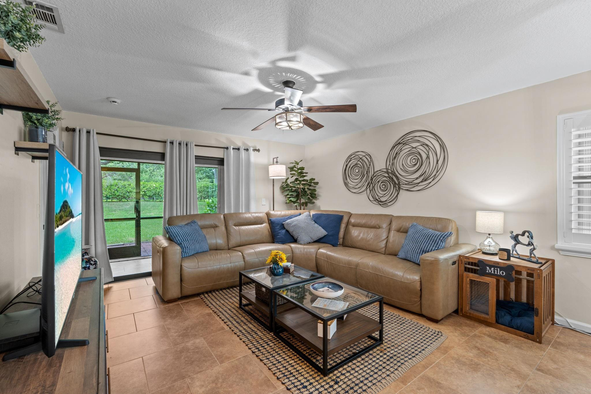 9601 Riverside Drive, Unit A6 Coral Springs, FL 33071 - Photo 7 of 25 a living room with furniture a clock and a large window
