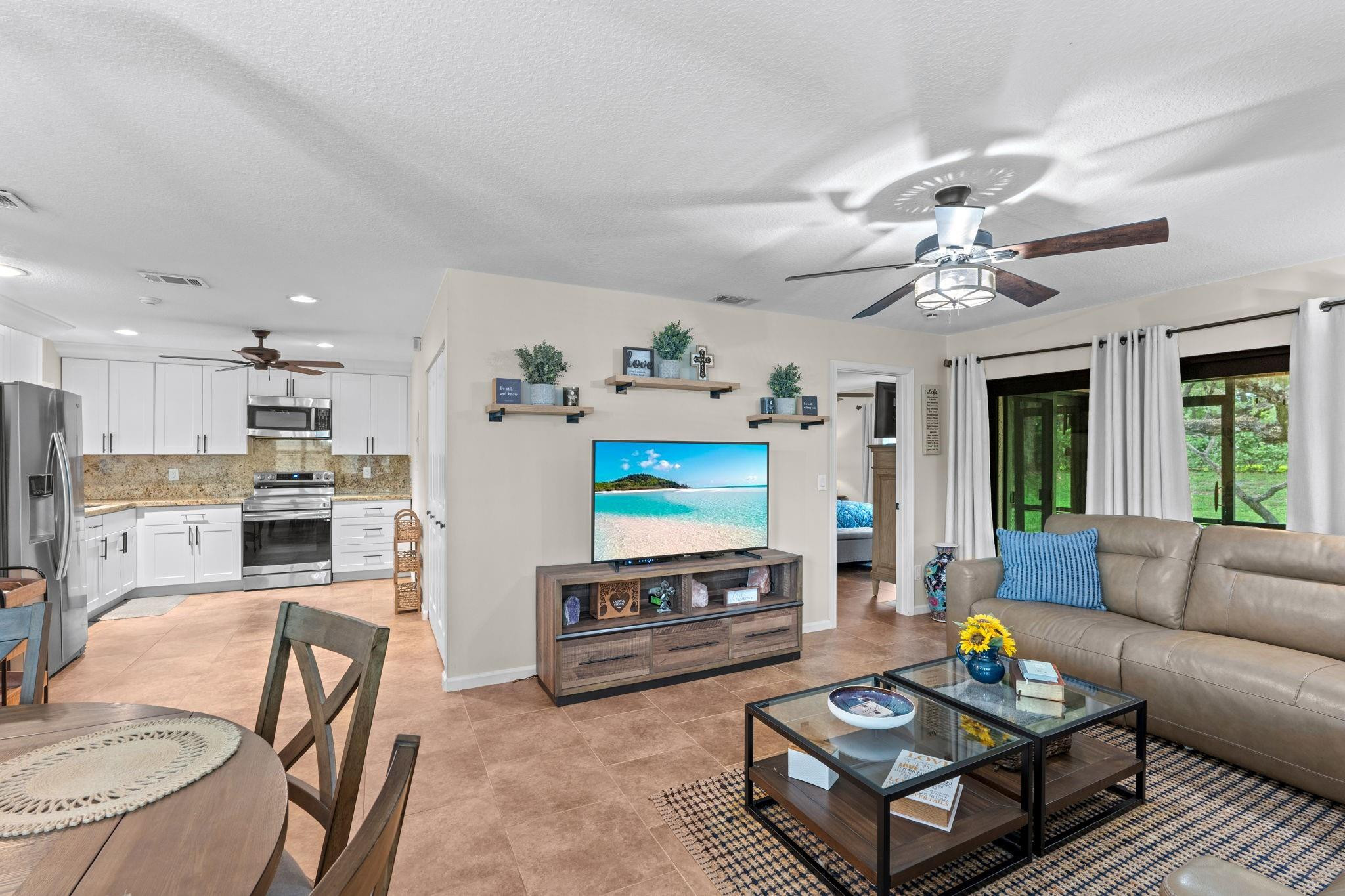 9601 Riverside Drive, Unit A6 Coral Springs, FL 33071 - Photo 8 of 25 a living room with furniture and a flat screen tv