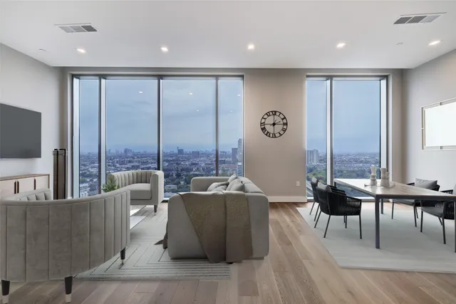 a living room with furniture potted plant and a large window